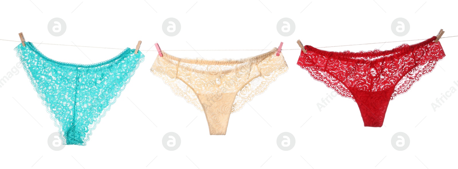 Beautiful panties on clothes line against white background Photo of Beautiful panties on clothes line against white background