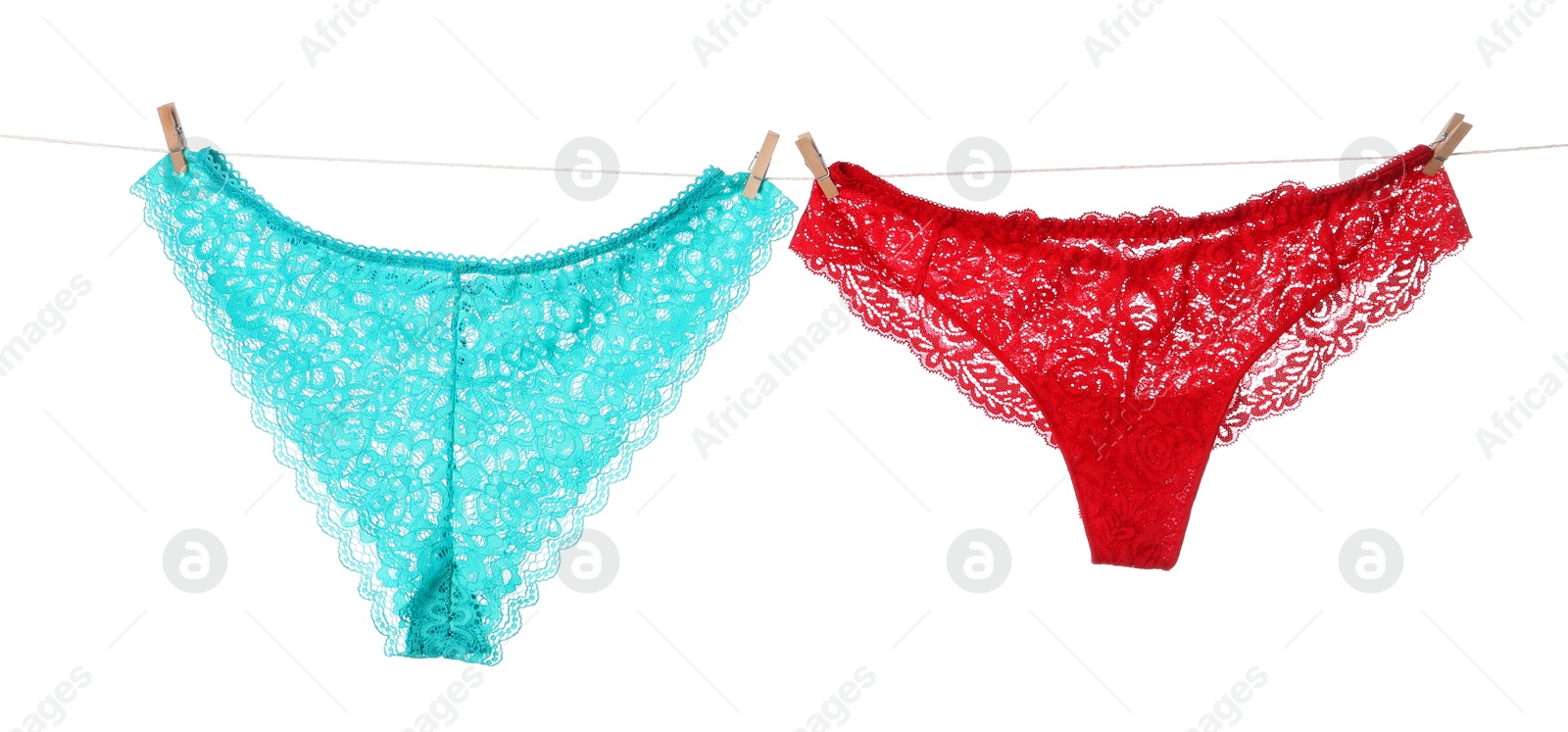 Beautiful panties on clothes line against white background Photo of Beautiful panties on clothes line against white background