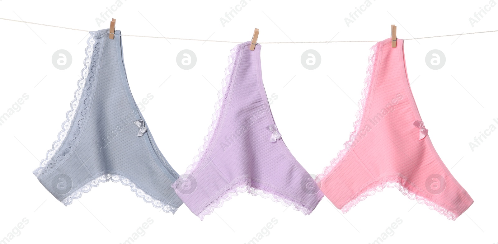 Beautiful panties on clothes line against white background Photo of Beautiful panties on clothes line against white background
