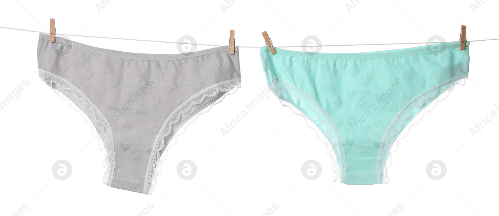 Beautiful panties on clothes line against white background Photo of Beautiful panties on clothes line against white background