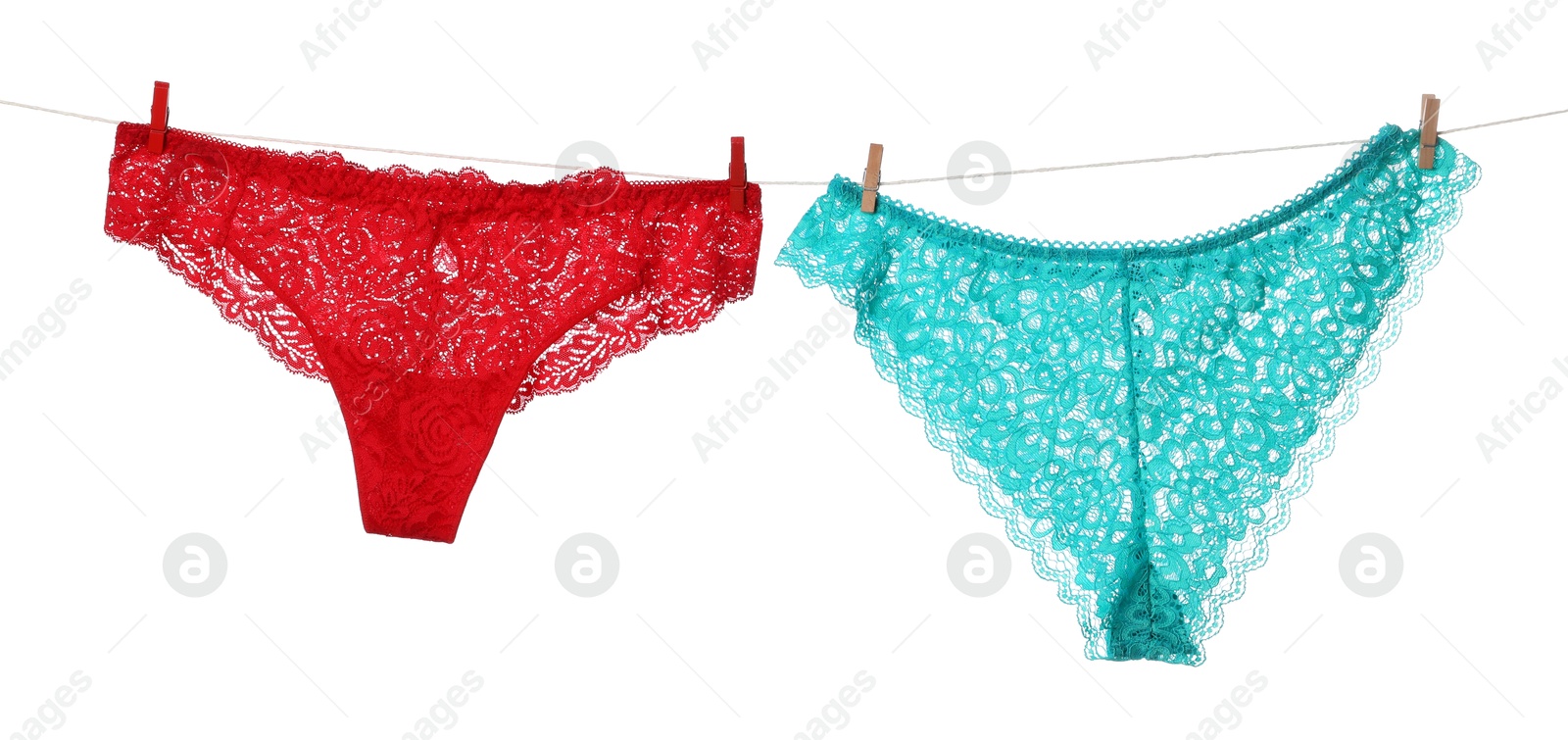 Beautiful panties on clothes line against white background Photo of Beautiful panties on clothes line against white background