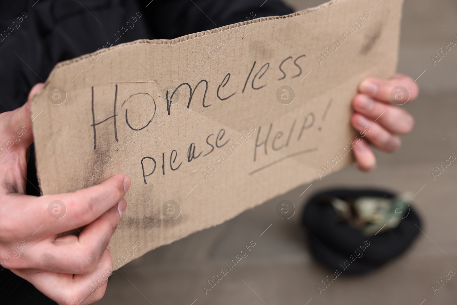 Man with sign Homeless please help outdoors, closeup Photo of Man with sign Homeless please help outdoors, closeup
