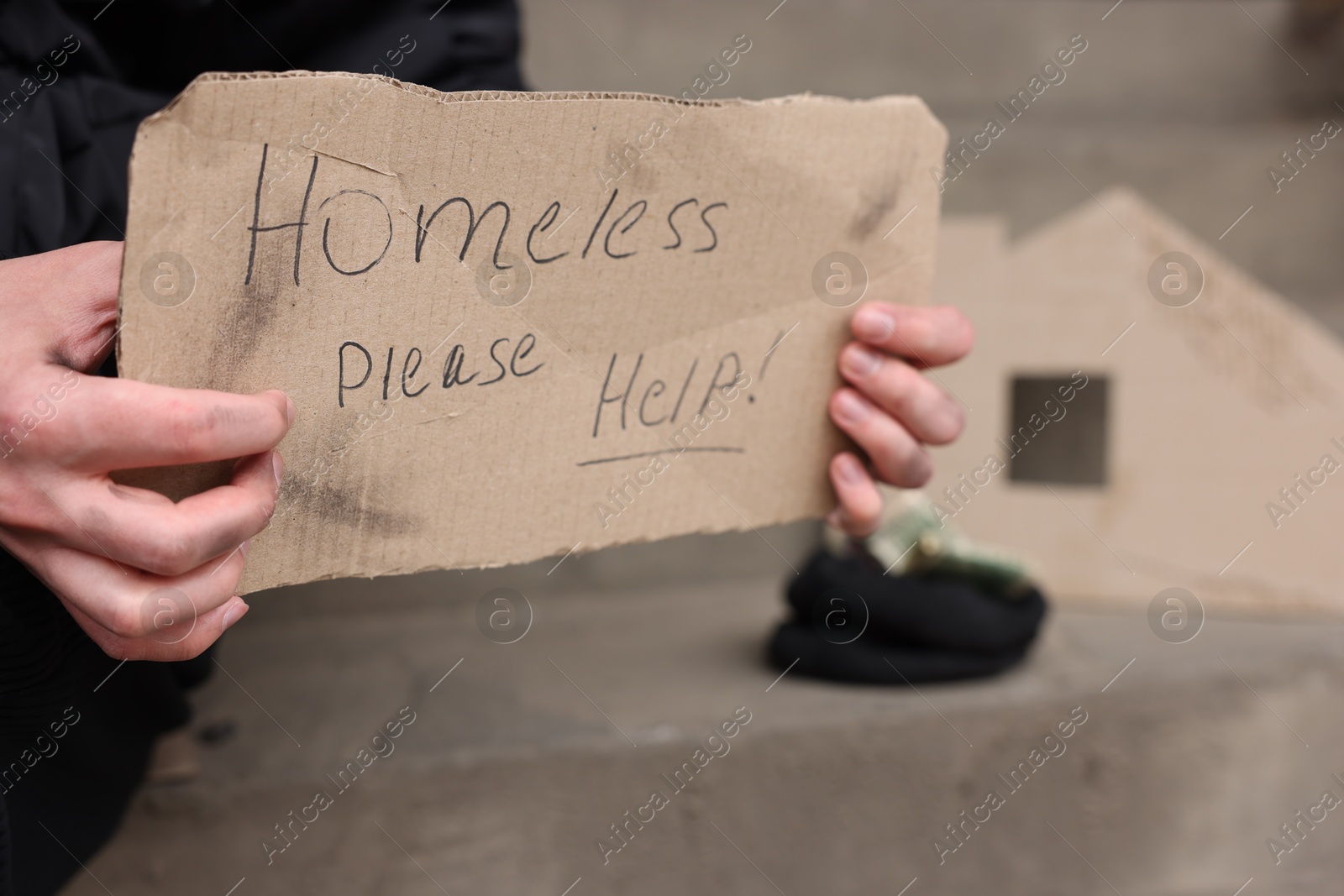 Man with sign Homeless please help outdoors, closeup Photo of Man with sign Homeless please help outdoors, closeup