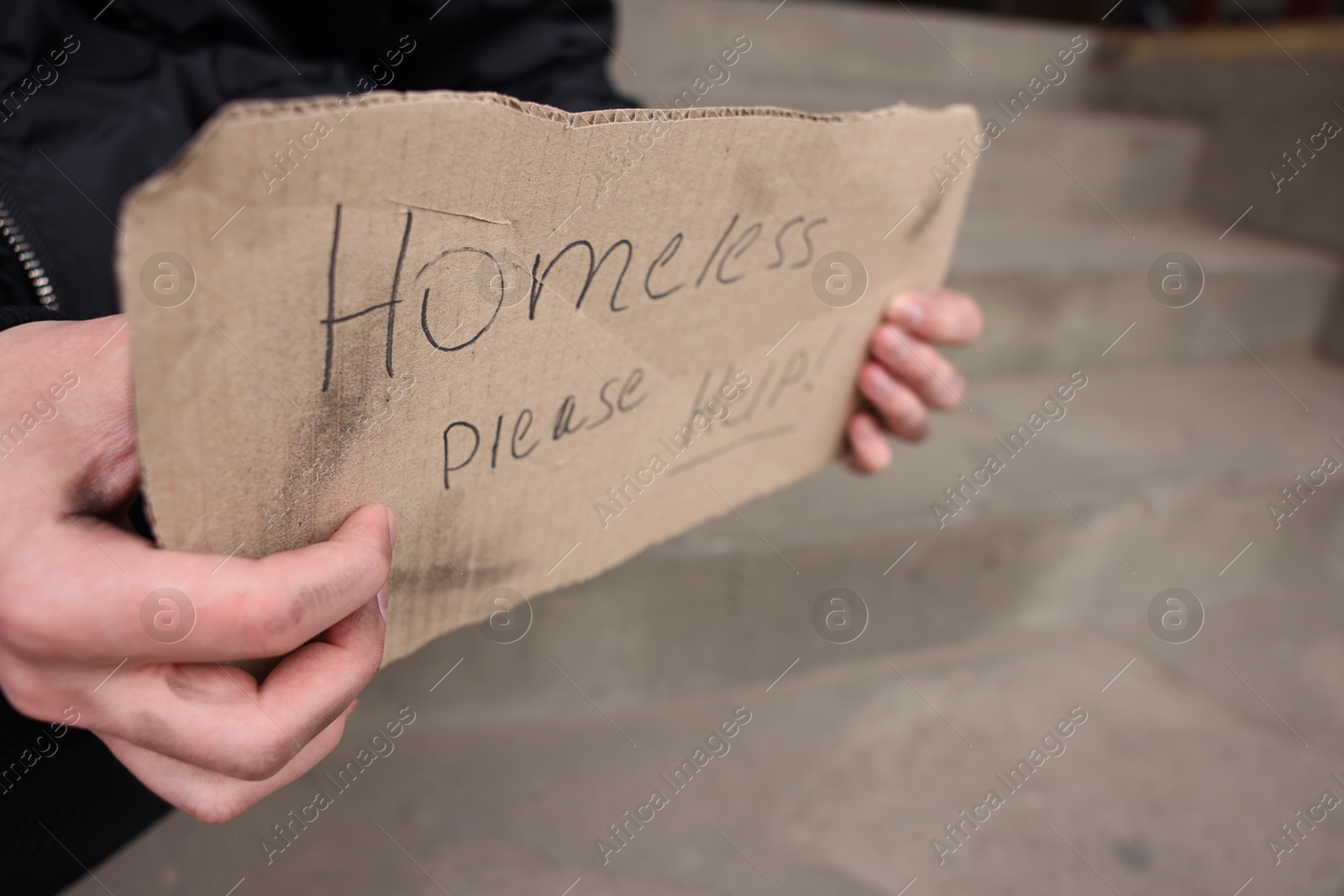 Man with sign Homeless please help outdoors, closeup Photo of Man with sign Homeless please help outdoors, closeup