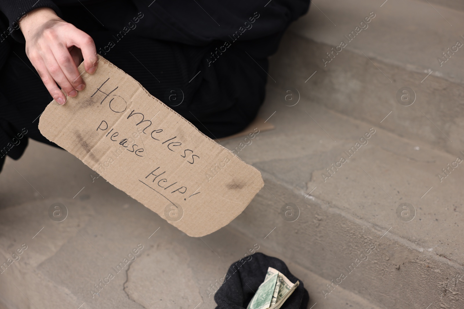 Man with sign Homeless please help and money outdoors, closeup Photo of Man with sign Homeless please help and money outdoors, closeup