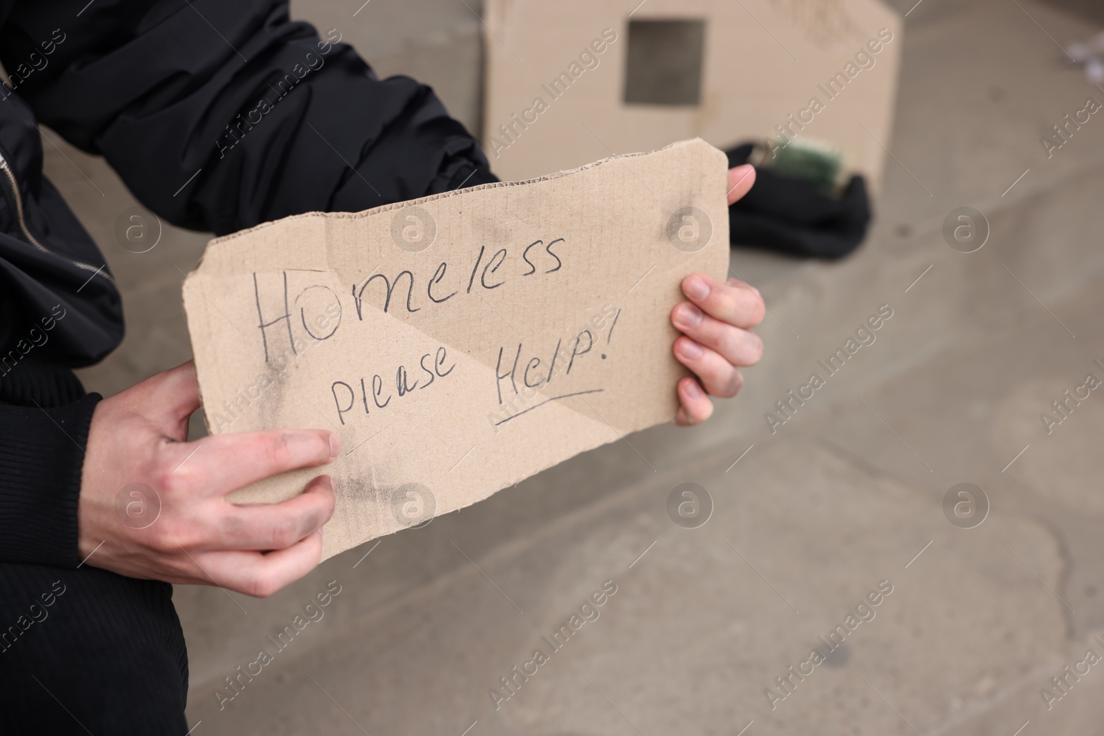 Man with sign Homeless please help outdoors, closeup Photo of Man with sign Homeless please help outdoors, closeup