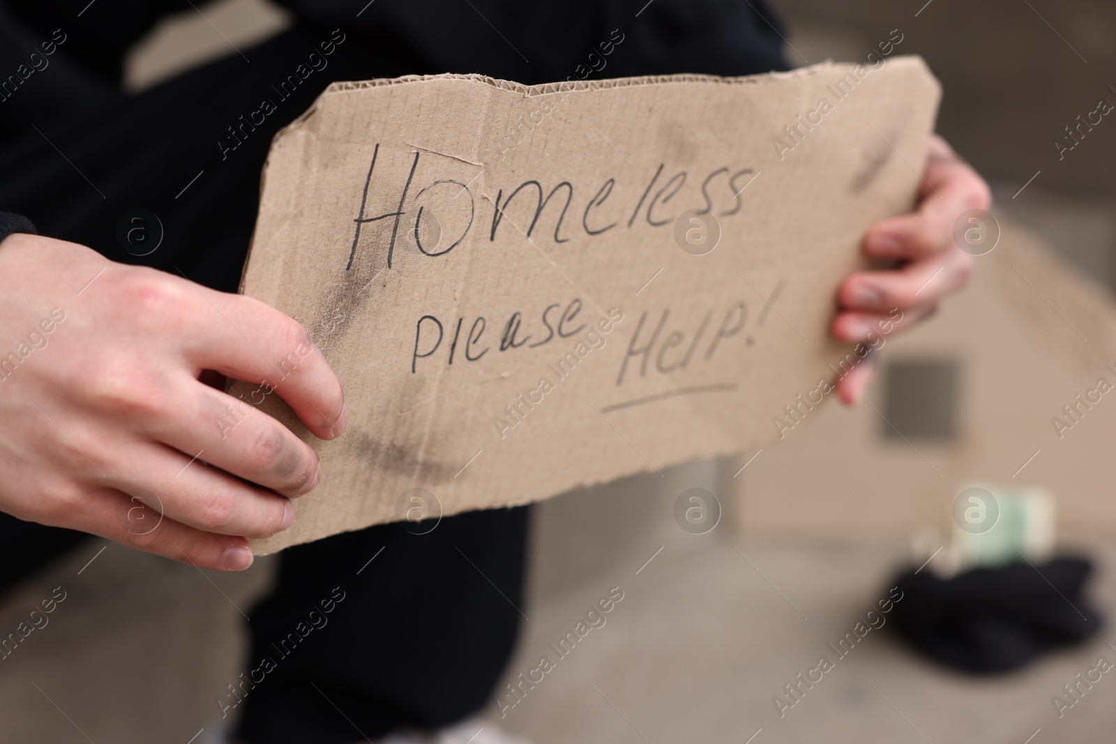 Man with sign Homeless please help outdoors, closeup Photo of Man with sign Homeless please help outdoors, closeup