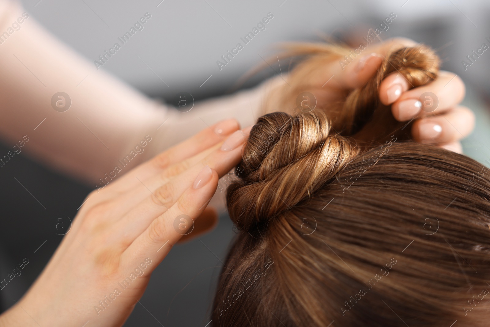 Hairdresser doing girl's hairstyle in salon, closeup Photo of Hairdresser doing girl's hairstyle in salon, closeup