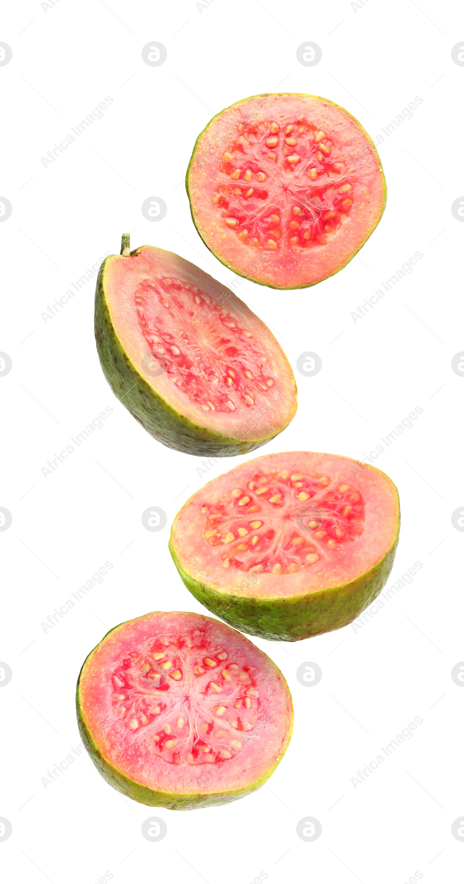 Fresh guavas. Pieces of fruits falling on white background Image of Fresh guavas. Pieces of fruits falling on white background