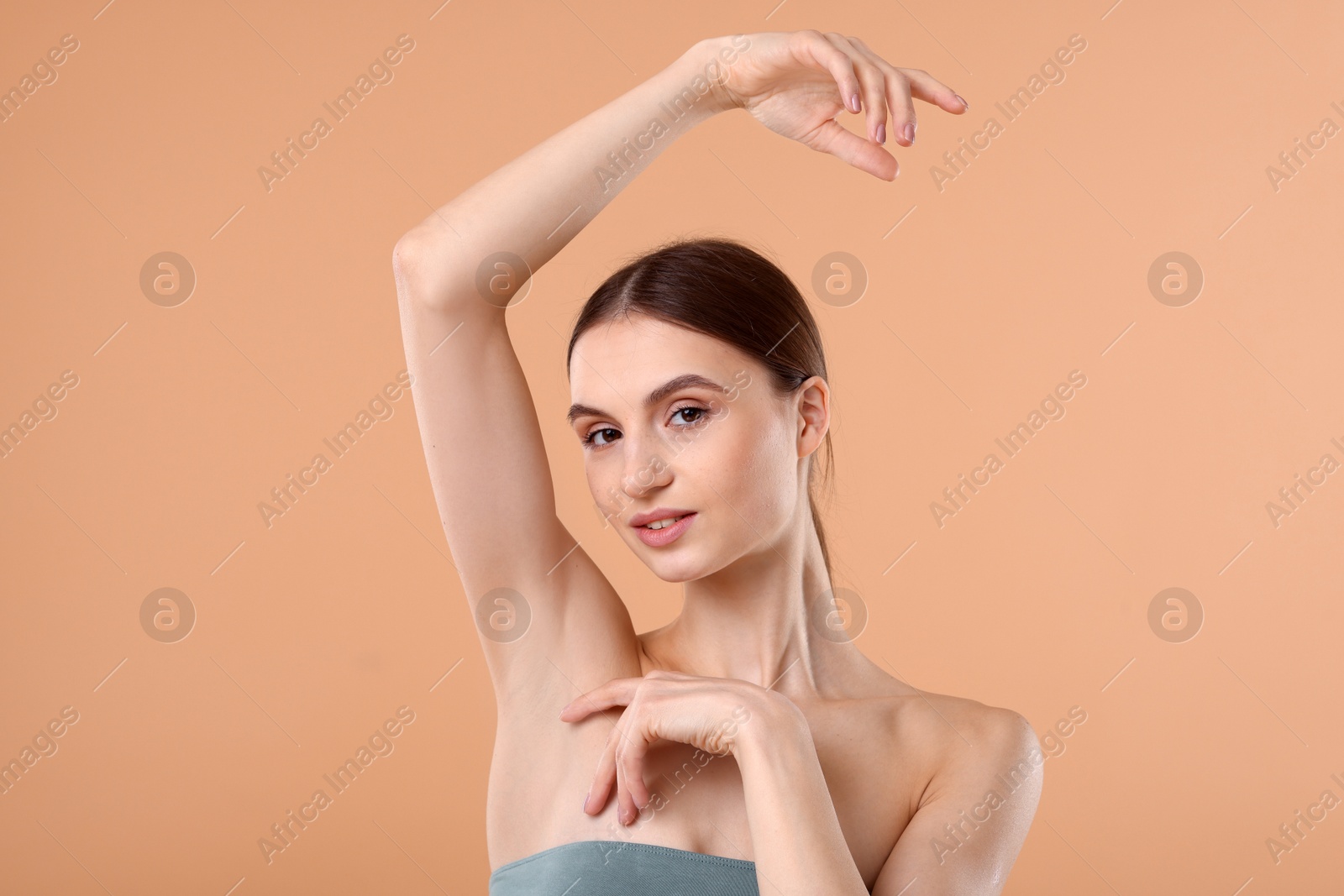 Young woman showing smooth skin after epilation on beige background Photo of Young woman showing smooth skin after epilation on beige background