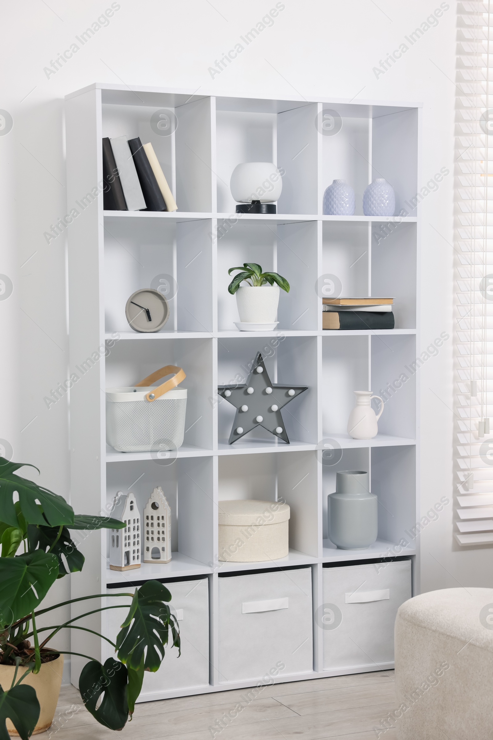 Shelving unit with different decor in room Photo of Shelving unit with different decor in room