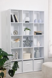 Photo of Shelving unit with different decor in room