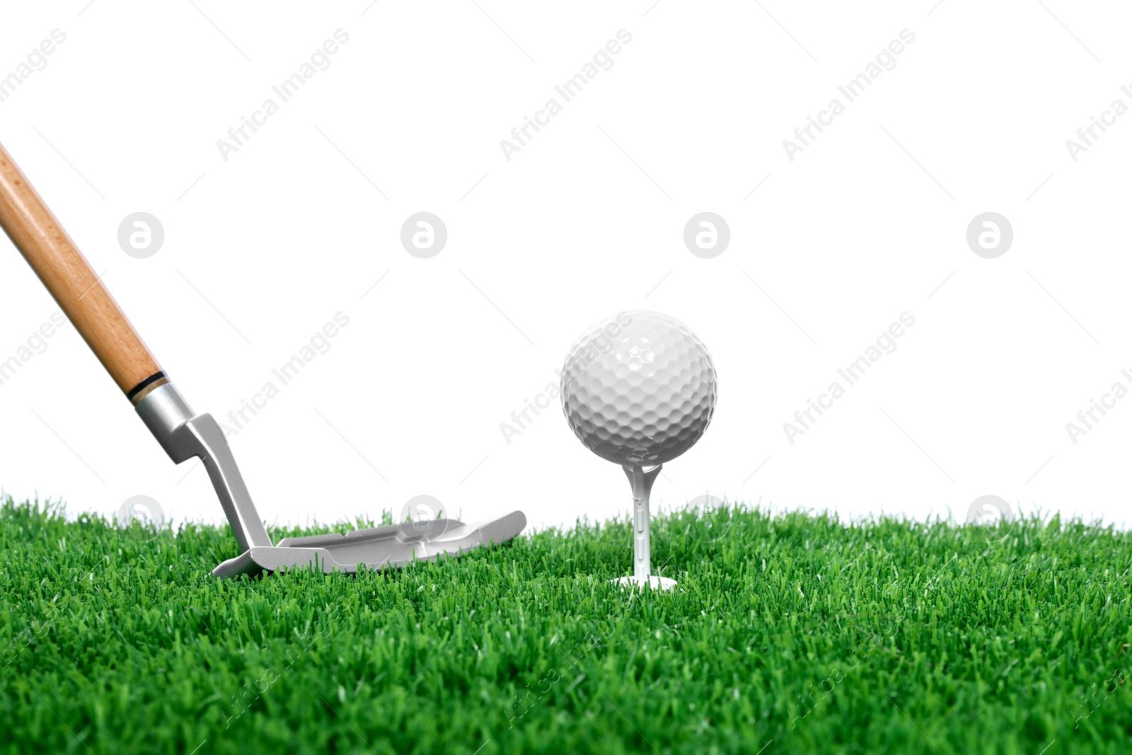 Golf ball, tee, club and green grass against white background Photo of Golf ball, tee, club and green grass against white background