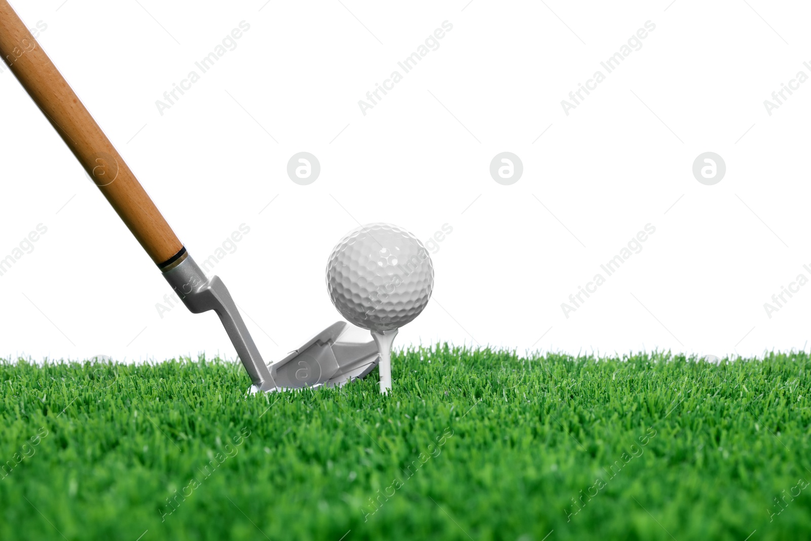 Golf ball, tee, club and green grass against white background Photo of Golf ball, tee, club and green grass against white background