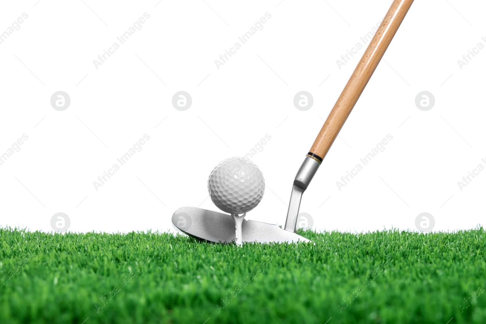 Photo of Golf ball, tee, club and green grass against white background