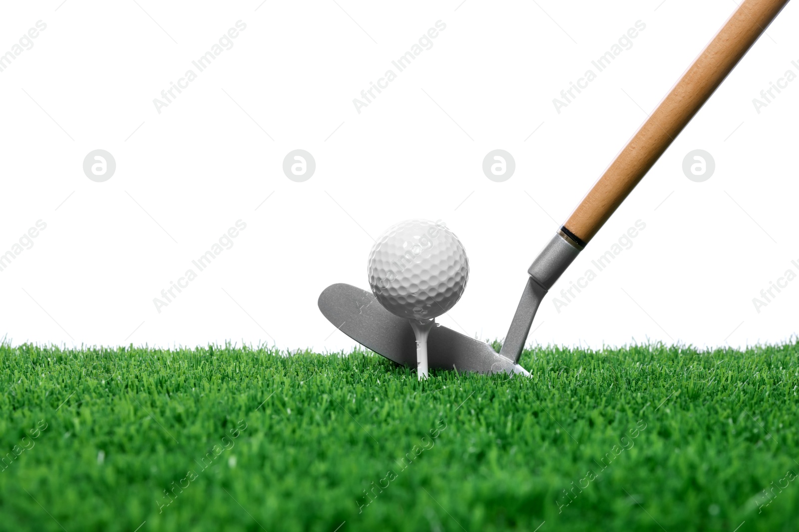 Golf ball, tee, club and green grass against white background Photo of Golf ball, tee, club and green grass against white background