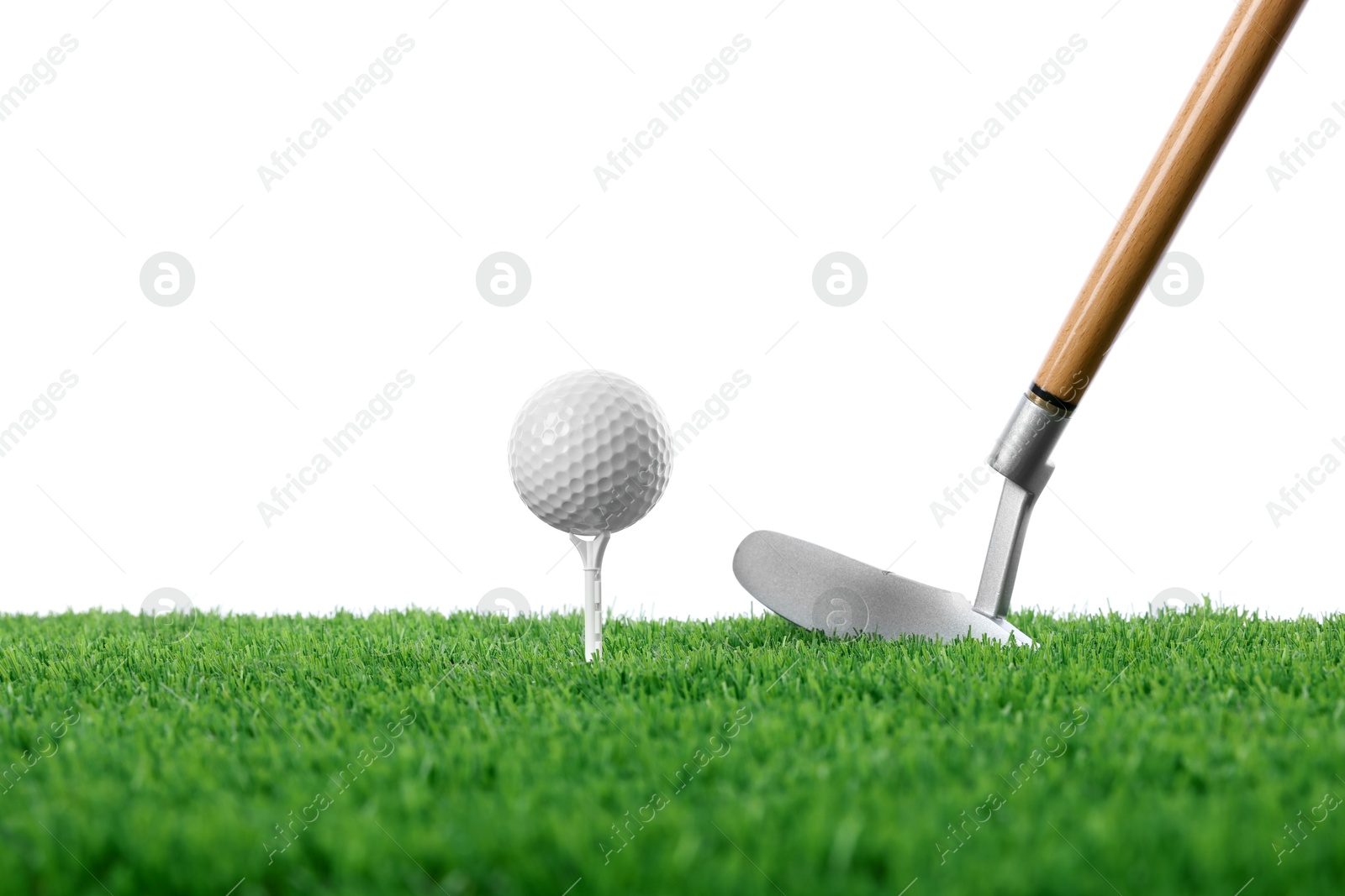 Golf ball, tee, club and green grass against white background Photo of Golf ball, tee, club and green grass against white background