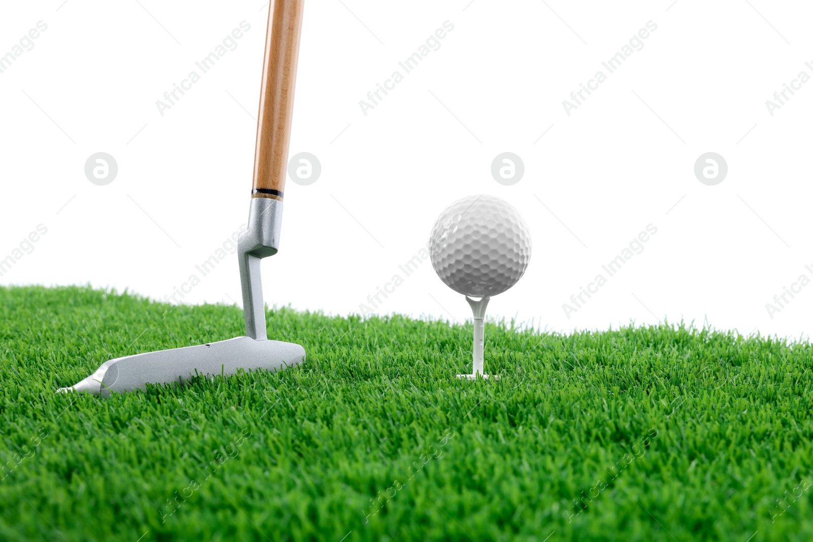 Golf ball, tee, club and green grass against white background Photo of Golf ball, tee, club and green grass against white background