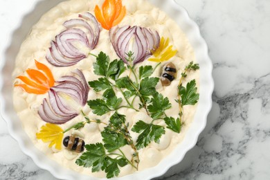 Photo of Raw focaccia with vegetables and olives in baking dish on white marble table, top view