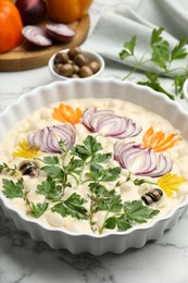 Photo of Raw focaccia with vegetables and olives on white marble table, closeup