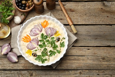 Photo of Raw focaccia with vegetables, olives, spices and brush on wooden table, flat lay. Space for text