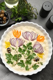 Photo of Raw focaccia with vegetables, olives and spices on grey table, flat lay