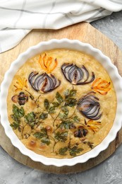 Photo of Delicious focaccia with flowers made of vegetables on grey textured table, top view