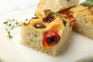 Photo of Pieces of delicious focaccia on table, closeup