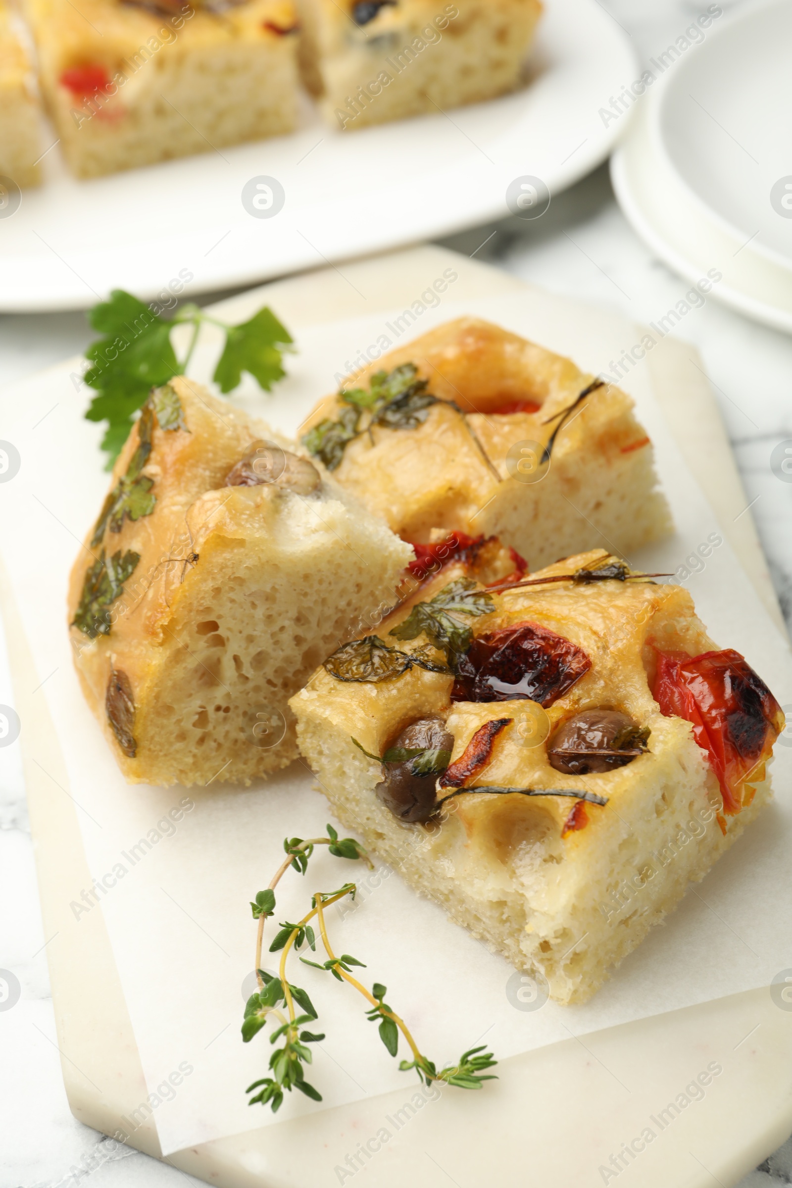 Pieces of delicious focaccia on white table, closeup Photo of Pieces of delicious focaccia on white table, closeup