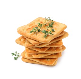 Photo of Tasty salty crackers with thyme isolated on white