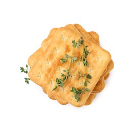 Photo of Tasty salty crackers with thyme isolated on white, top view