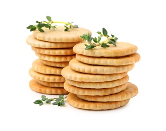 Photo of Tasty salty crackers with thyme isolated on white