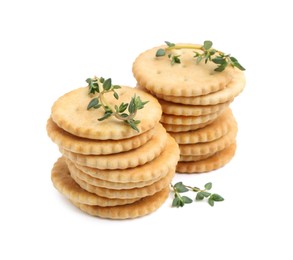 Photo of Tasty salty crackers with thyme isolated on white