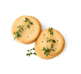 Photo of Tasty salty crackers with thyme isolated on white, top view