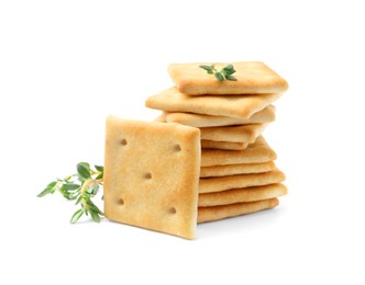 Photo of Tasty salty crackers with thyme isolated on white