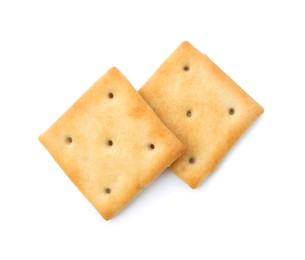 Photo of Tasty salty crackers isolated on white, top view