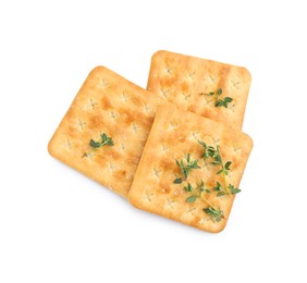 Photo of Tasty salty crackers with thyme isolated on white, top view