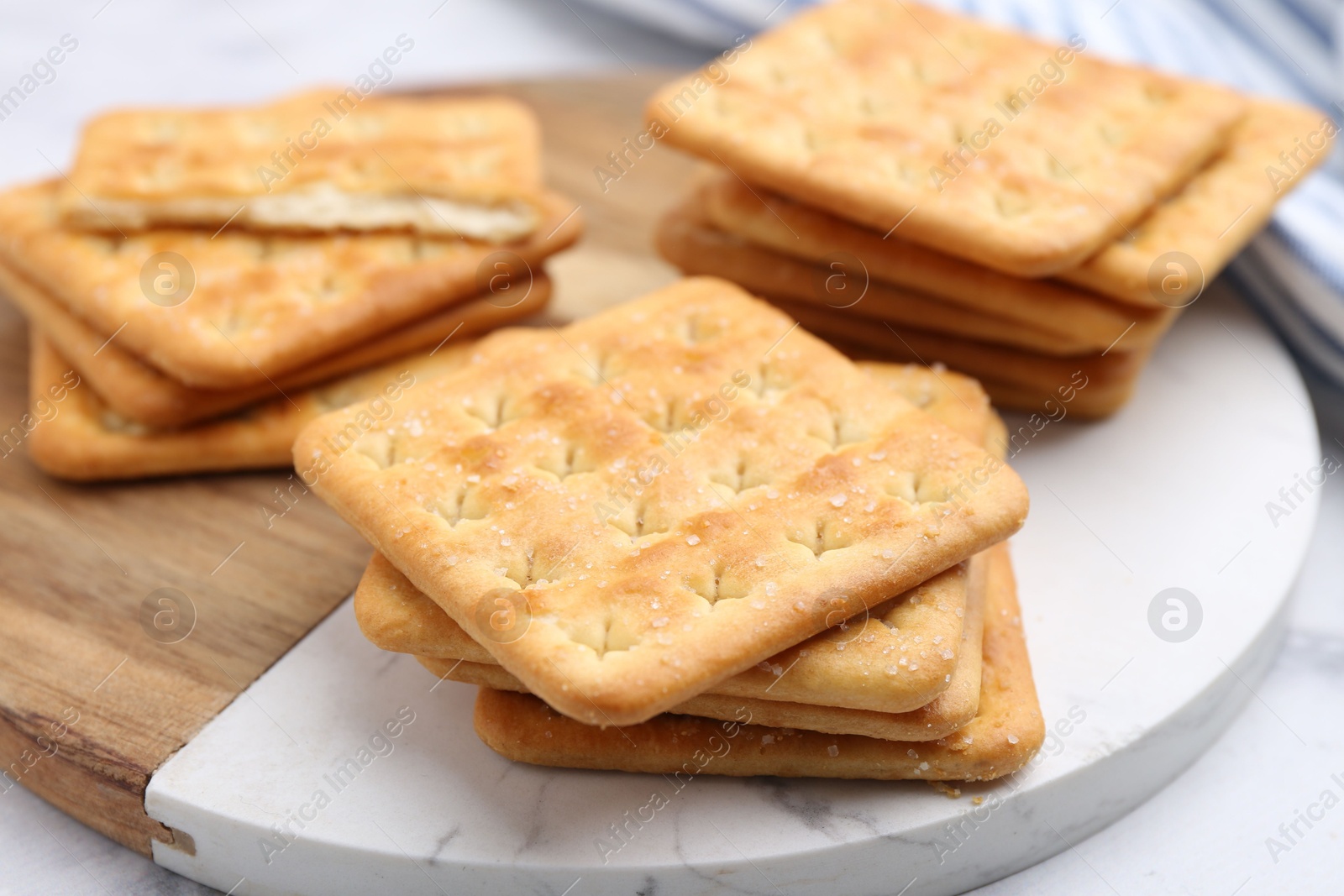 Tasty salty crackers on white table, closeup Photo of Tasty salty crackers on white table, closeup