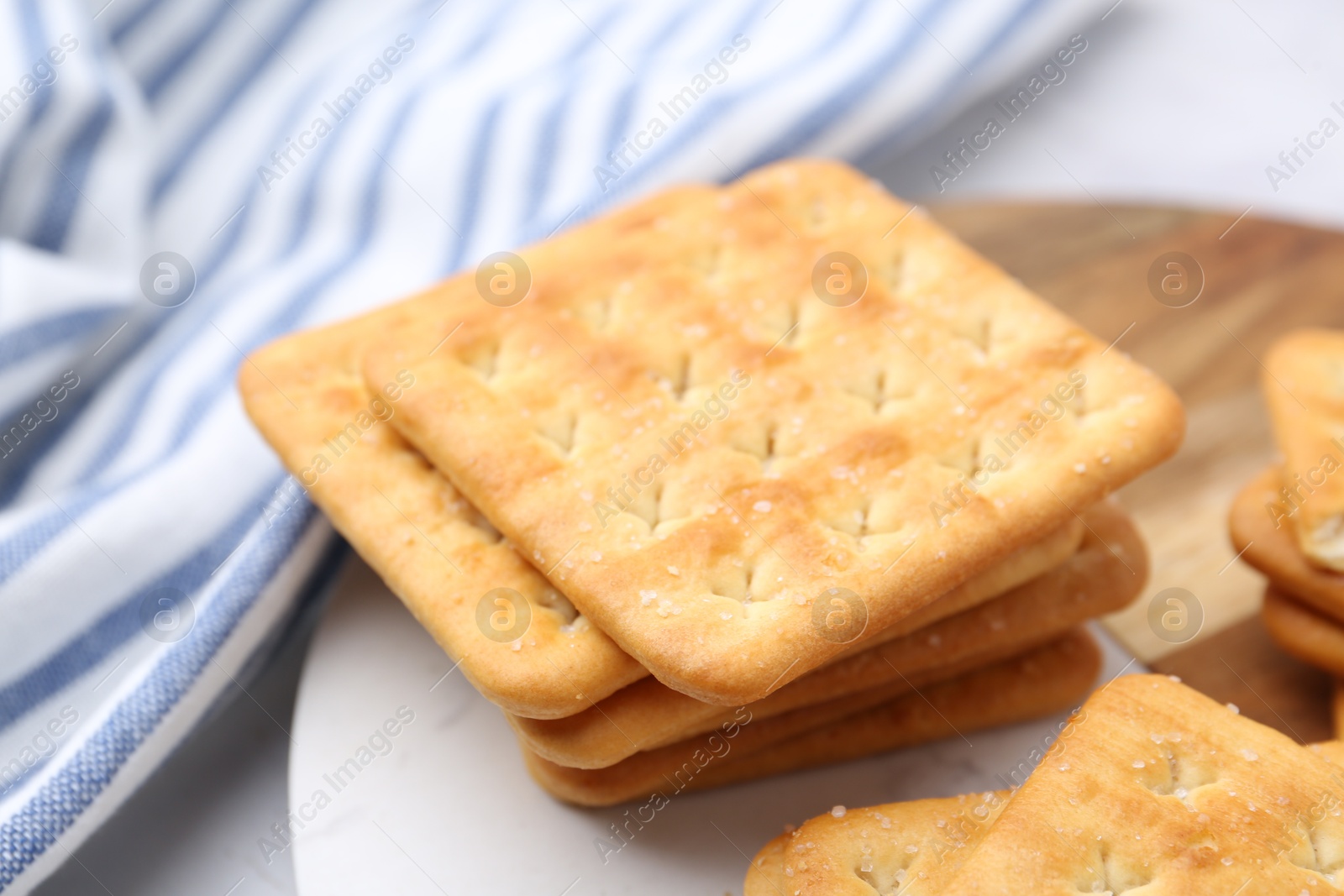 Tasty salty crackers on white table, closeup Photo of Tasty salty crackers on white table, closeup