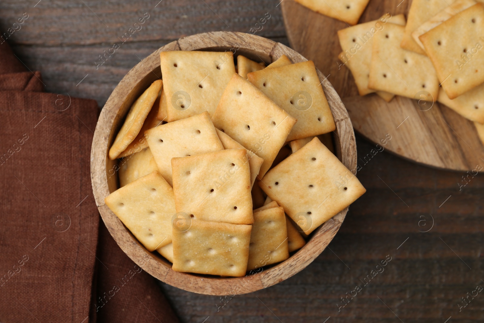 Tasty salty crackers on wooden table, top view Photo of Tasty salty crackers on wooden table, top view