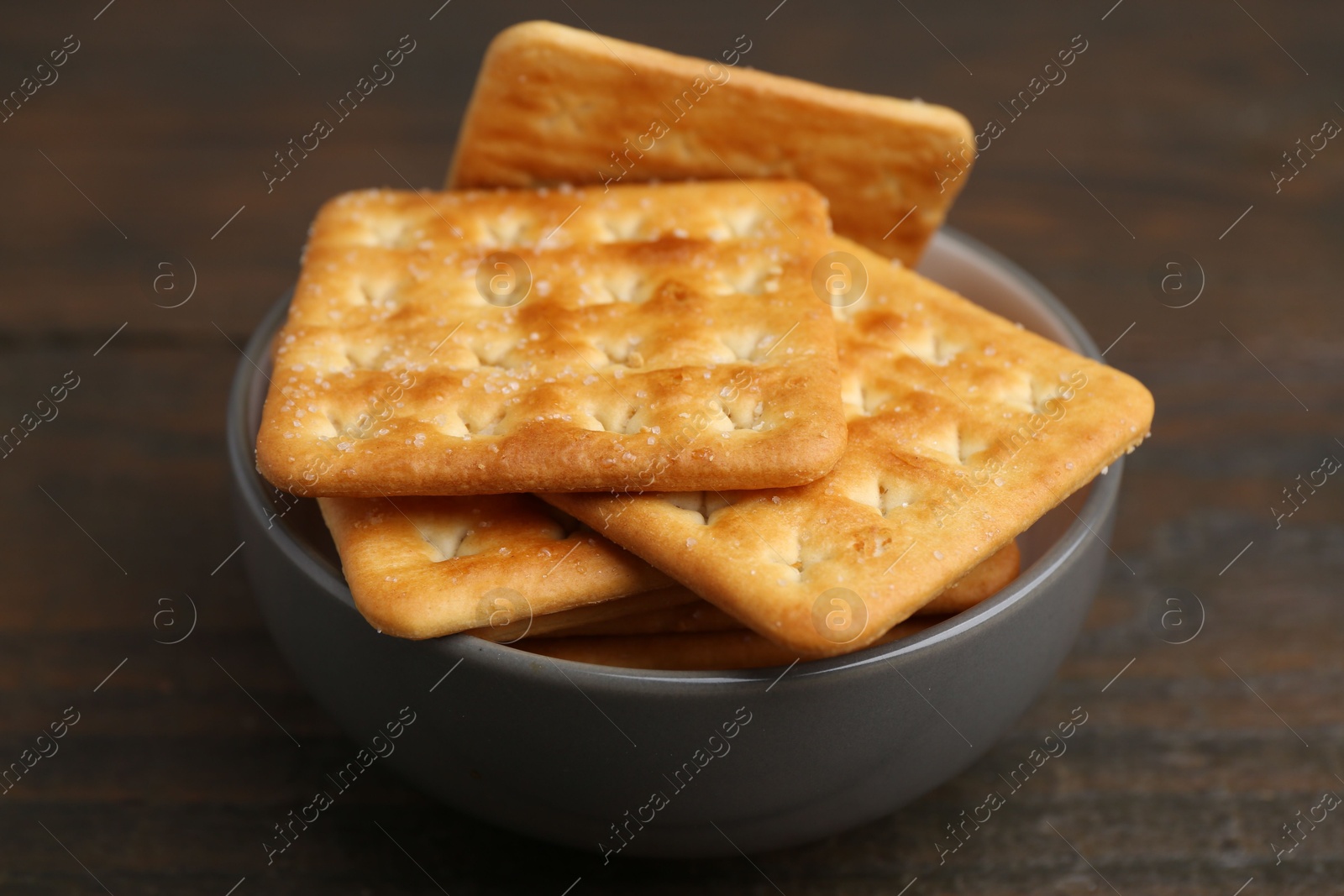 Tasty salty crackers on wooden table, closeup Photo of Tasty salty crackers on wooden table, closeup