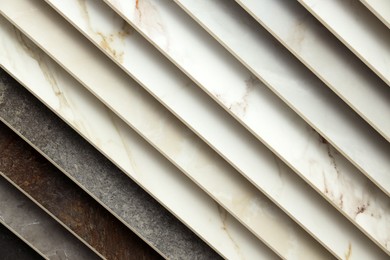 Photo of Many different samples of tiles as background, closeup