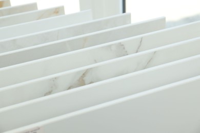 Photo of Many different samples of tiles on display in store, closeup