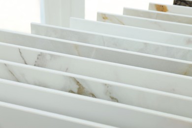 Photo of Many different samples of tiles on display in store, closeup