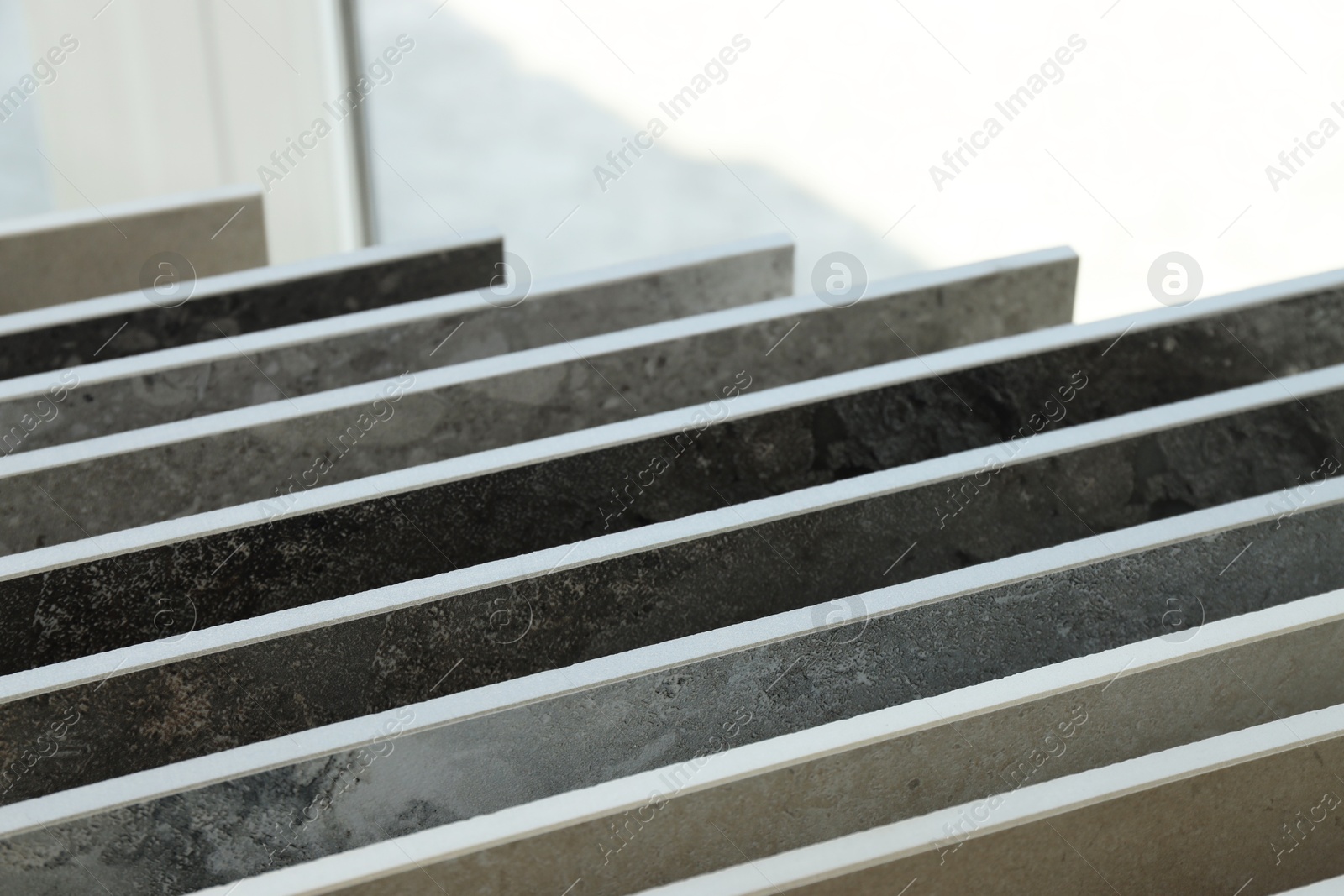 Many different samples of tiles on display in store, closeup Photo of Many different samples of tiles on display in store, closeup