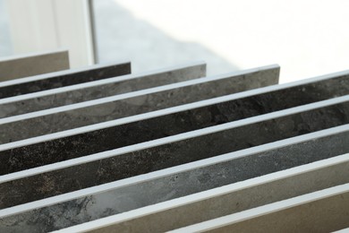 Photo of Many different samples of tiles on display in store, closeup