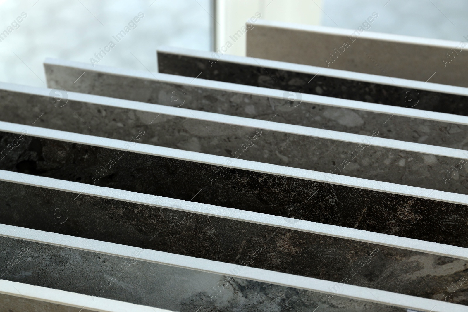 Many different samples of tiles on display in store, closeup Photo of Many different samples of tiles on display in store, closeup