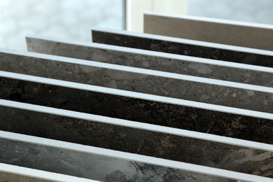 Photo of Many different samples of tiles on display in store, closeup