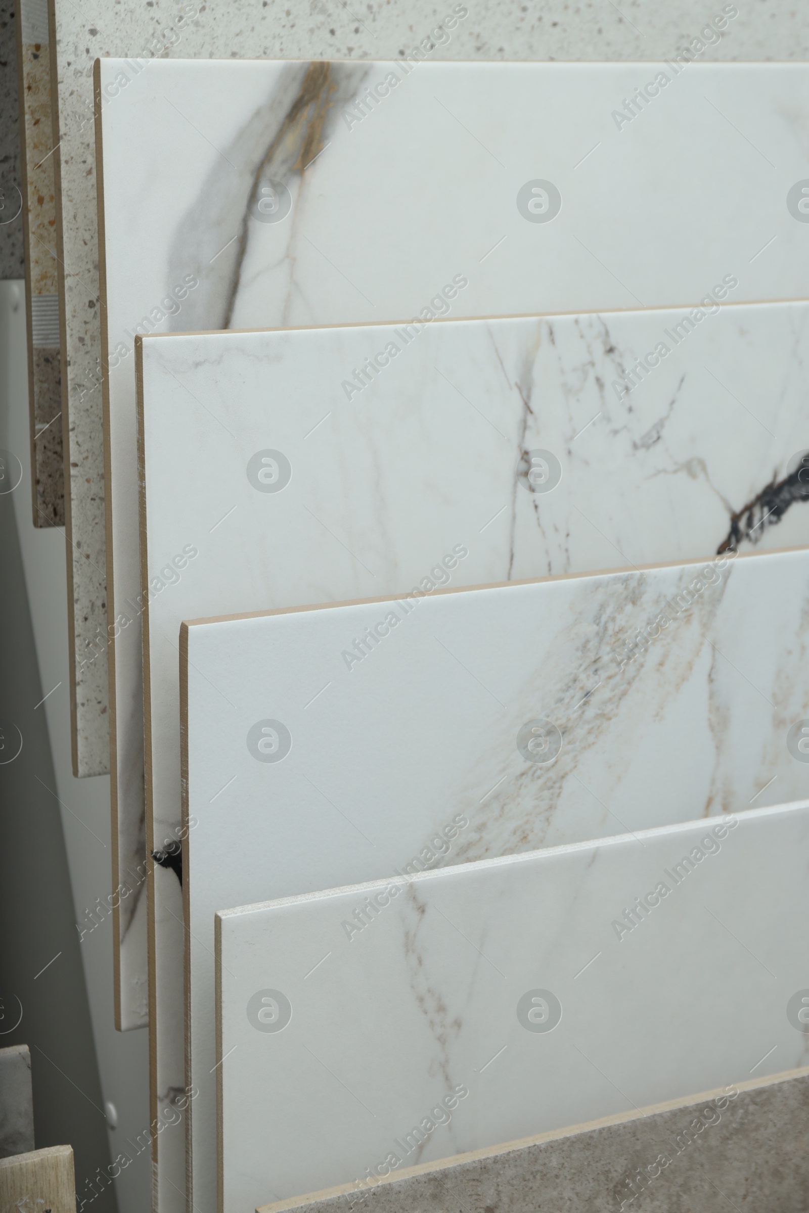 Many different samples of tiles on display in store, closeup Photo of Many different samples of tiles on display in store, closeup