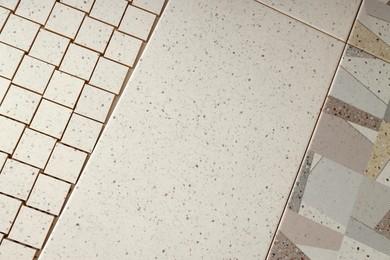 Photo of Texture of tiles with beautiful patterns as background, above view